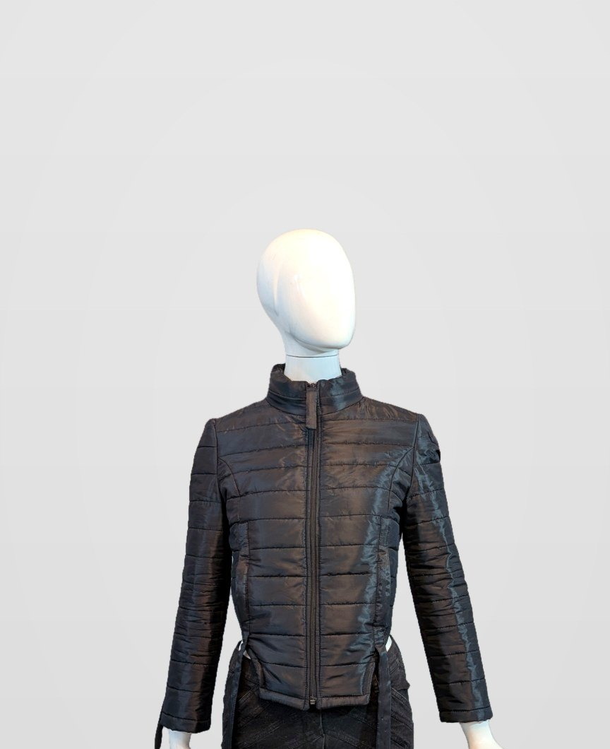 Black Nova Puffer front view during construction on a mannequin, framed just below the jacket hem